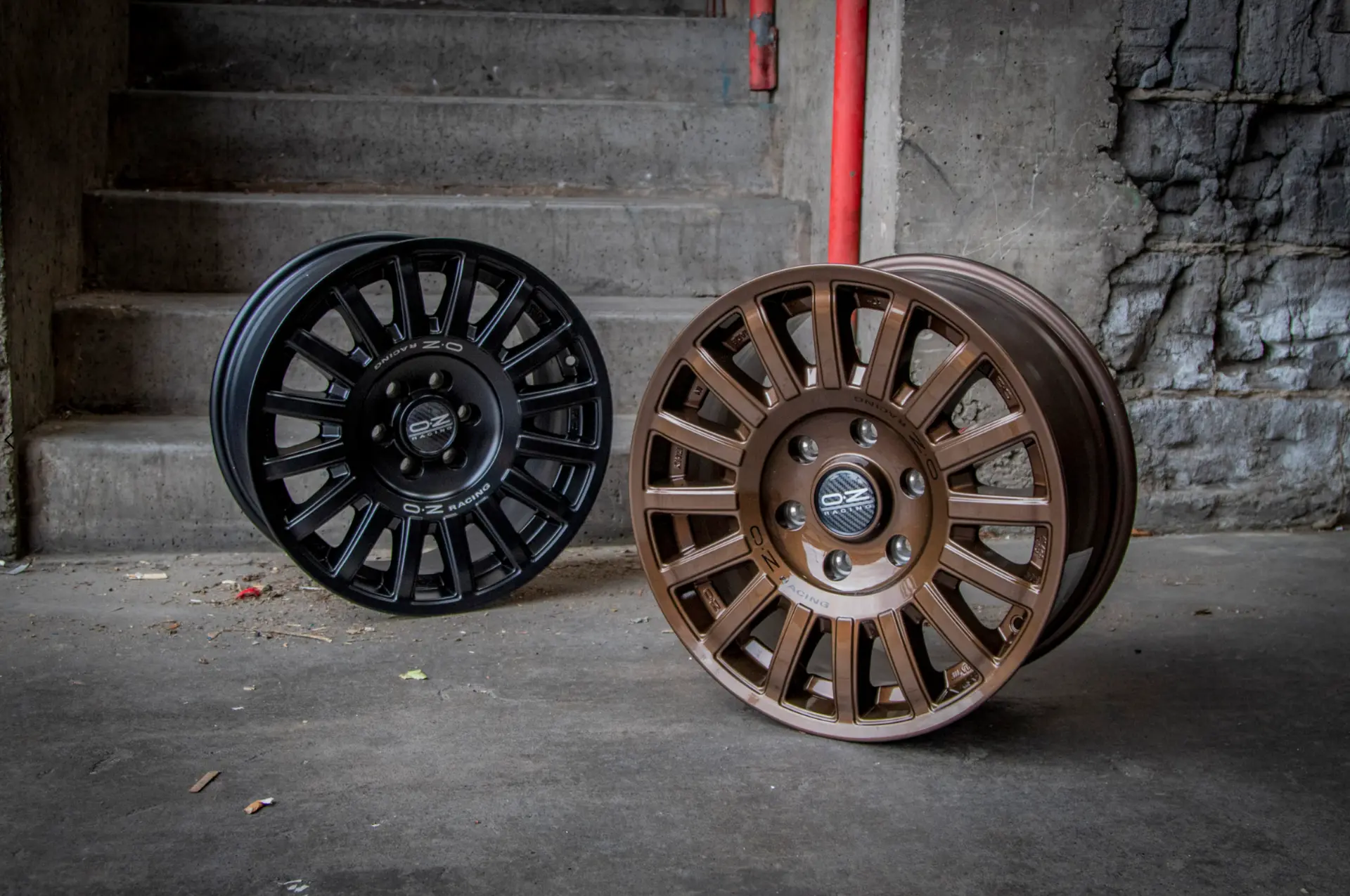 OZ Racing wheels in black and bronze against concrete steps