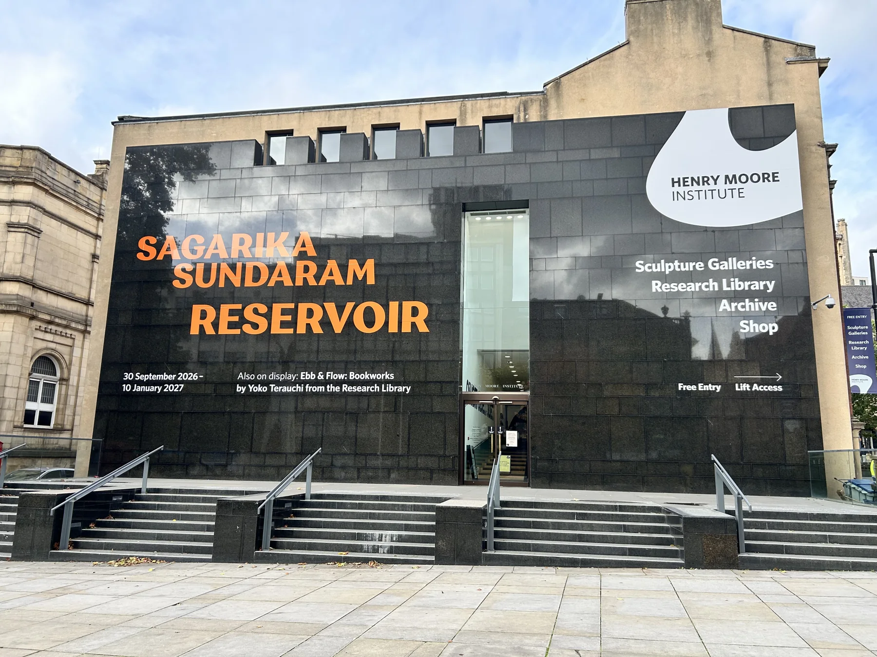 Orange exhibition lettering on the Henry Moore Institute façade
