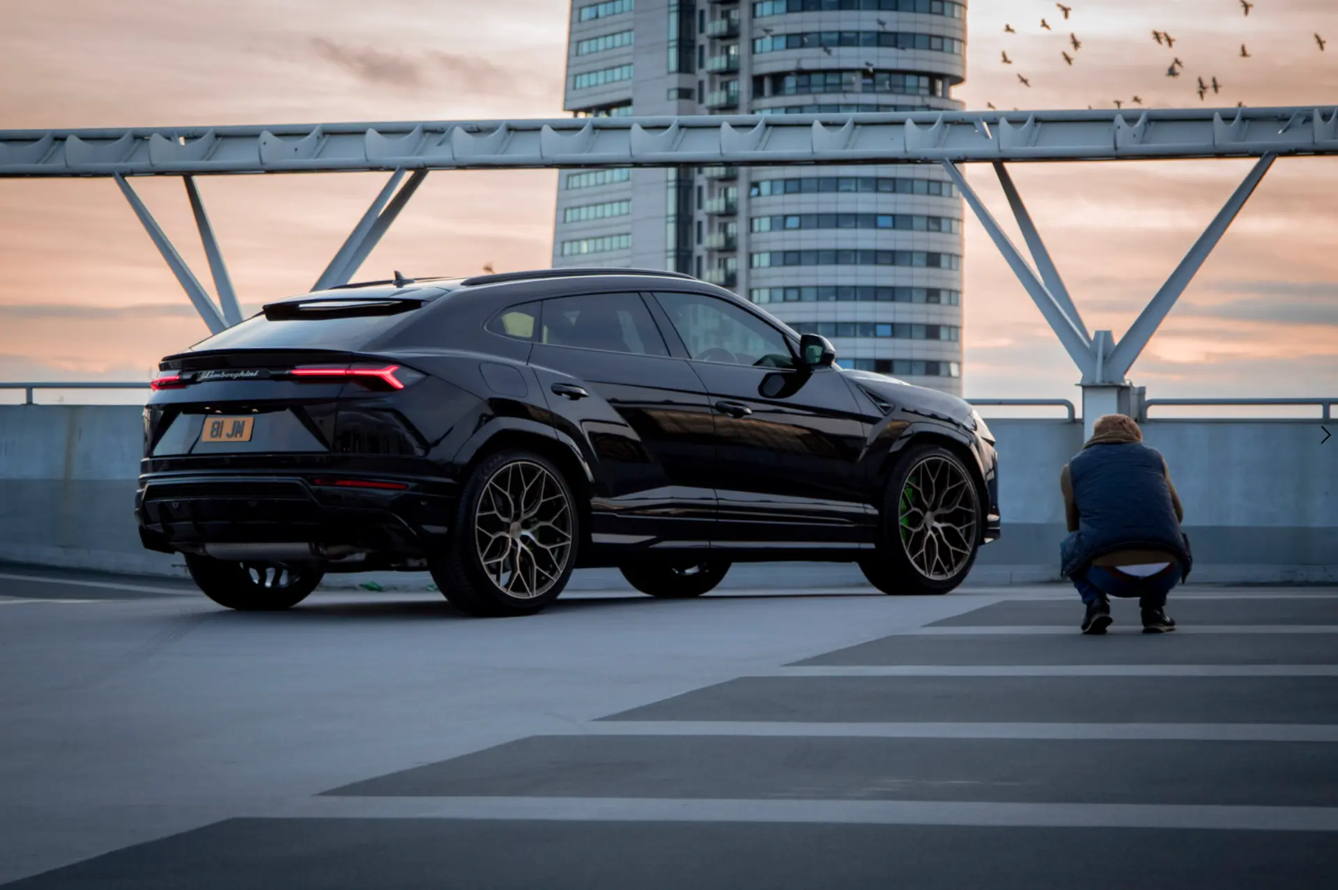 Moody automotive photography of a dark sports car at dusk